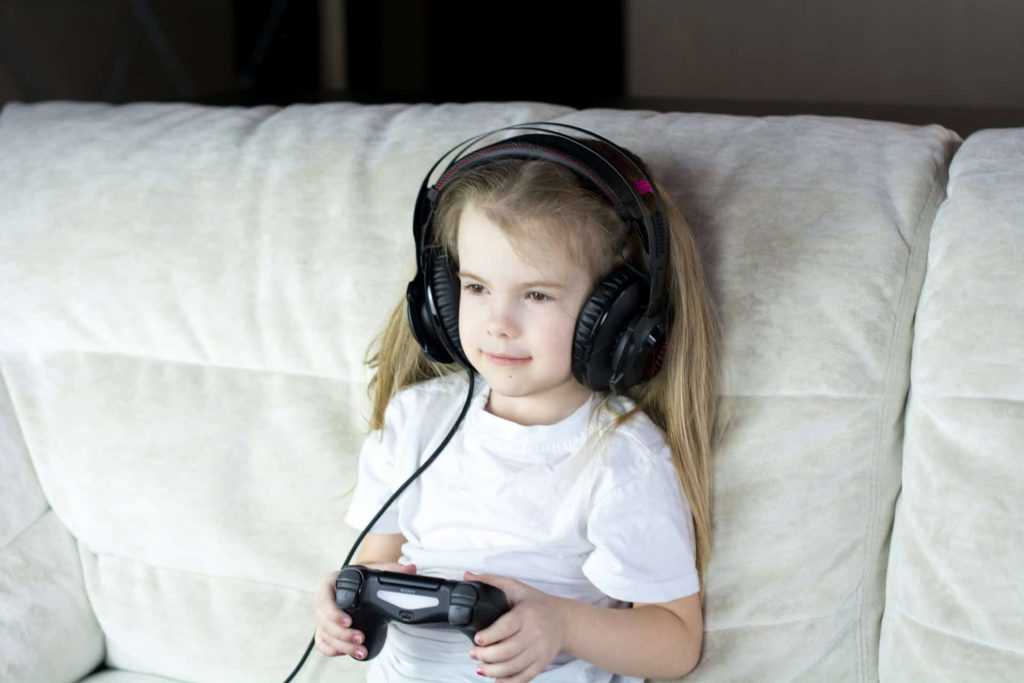 Young girl playing on her electronics