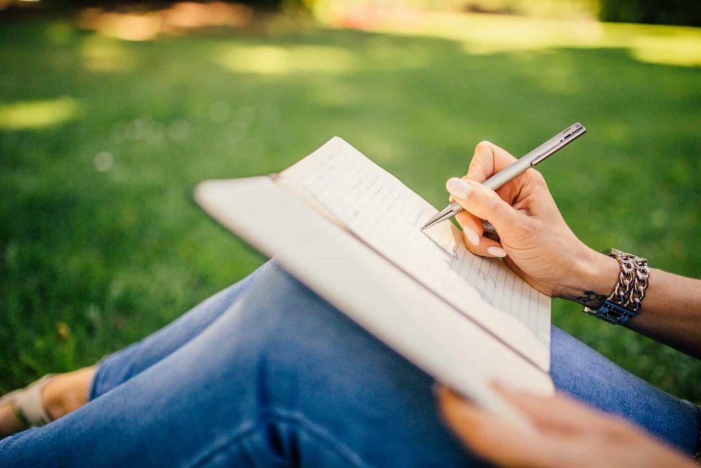 A person journaling outside