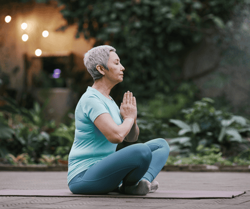 An older woman practicing yoga